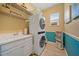 Well-equipped laundry room with a sink, stacked washer and dryer, and additional shelving at 1962 Flora Pass Pl, Kissimmee, FL 34747