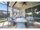 A covered, screened patio boasts comfortable seating and views of the outdoor pool area at 1962 Flora Pass Pl, Kissimmee, FL 34747
