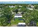 Aerial view of the home showcasing the backyard, mature trees, and surrounding neighborhood at 207 Kay St, Auburndale, FL 33823