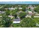 An aerial view showcasing the property and its surroundings with lush greenery at 207 Kay St, Auburndale, FL 33823