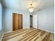 Bright bedroom featuring unique wood-style flooring, a chandelier, and neutral walls at 207 Kay St, Auburndale, FL 33823