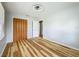 Bright bedroom with wood floors, ceiling fan and bifold closet doors at 207 Kay St, Auburndale, FL 33823