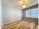 Bright bedroom featuring unique wood-style flooring, a chandelier, and neutral walls at 207 Kay St, Auburndale, FL 33823