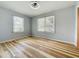 Bedroom featuring two windows with blinds allowing ample natural light at 207 Kay St, Auburndale, FL 33823