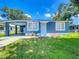 Charming blue home with a well-maintained front yard and a convenient carport at 207 Kay St, Auburndale, FL 33823