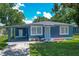 Charming blue home with a well-maintained front yard and a convenient carport at 207 Kay St, Auburndale, FL 33823