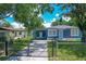 Charming blue home with a fenced yard and a convenient carport at 207 Kay St, Auburndale, FL 33823