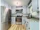 Charming kitchen with gray cabinets, stainless steel appliances and new flooring at 207 Kay St, Auburndale, FL 33823