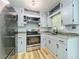 Charming kitchen with gray cabinets and stainless steel appliances at 207 Kay St, Auburndale, FL 33823