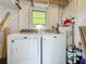 Convenient laundry room area with a washer, dryer, and water heater at 207 Kay St, Auburndale, FL 33823