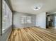 Bright living room features neutral paint, light fixture, and natural light from large windows at 207 Kay St, Auburndale, FL 33823