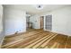 Bright living room featuring wood floors, neutral paint, and a built-in bookcase at 207 Kay St, Auburndale, FL 33823