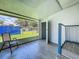 Enclosed porch area with tile flooring and views of the private backyard at 207 Kay St, Auburndale, FL 33823