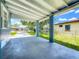 Covered front porch with blue pillars offers an outdoor space at 207 Kay St, Auburndale, FL 33823