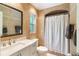 Tiled bathroom with arched shower and modern vanity featuring ample counter space and storage at 209 Carriage Hill Dr, Casselberry, FL 32707