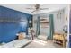 bedroom with a blue accent wall, cozy sleeping area, and space for play and creativity at 209 Carriage Hill Dr, Casselberry, FL 32707