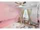 bedroom with a pink accent wall, cozy sleeping area, and space for play and creativity at 209 Carriage Hill Dr, Casselberry, FL 32707