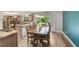 Open-concept dining area featuring hardwood floors, modern lighting, and easy access to the kitchen at 209 Carriage Hill Dr, Casselberry, FL 32707