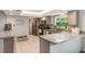 Well-lit kitchen featuring granite countertops, stainless appliances, and tiled backsplash at 209 Carriage Hill Dr, Casselberry, FL 32707