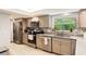 Well-lit kitchen featuring granite countertops, stainless appliances, and modern cabinetry at 209 Carriage Hill Dr, Casselberry, FL 32707