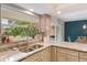 Bright kitchen featuring granite counters, stainless steel sink, and large window overlooking the backyard at 209 Carriage Hill Dr, Casselberry, FL 32707