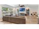 Bright living room featuring hardwood floors, large windows, and comfortable seating at 209 Carriage Hill Dr, Casselberry, FL 32707