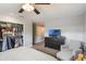 Bright bedroom with an organized walk-in closet, dresser with TV, and seating area at 209 Carriage Hill Dr, Casselberry, FL 32707