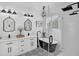 Luxurious bathroom featuring a freestanding tub, glass-enclosed shower, patterned tile floor and dual vanity at 215 Foxglove Way, Deland, FL 32724