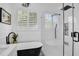 Modern bathroom featuring a black and white tub, walk-in shower and white subway tile at 215 Foxglove Way, Deland, FL 32724
