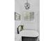 Bright bathroom with freestanding tub, plantation shutters, and chandelier at 215 Foxglove Way, Deland, FL 32724