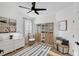 Bright bedroom with natural light, wood floors, a decorative rug, modern furnishings, and built in shelving at 215 Foxglove Way, Deland, FL 32724