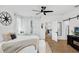 Bright bedroom featuring a hardwood floor and a barn door to a closet at 215 Foxglove Way, Deland, FL 32724
