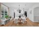 Dining area features a modern chandelier, lots of natural light, and opens to the kitchen at 215 Foxglove Way, Deland, FL 32724