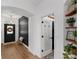 Inviting foyer featuring a decorative black door, wooden floors, and stylish wall accents at 215 Foxglove Way, Deland, FL 32724