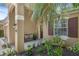 Inviting front porch with seating, lush landscaping, and charming home number display at 215 Foxglove Way, Deland, FL 32724