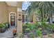 Inviting front porch with seating, lush landscaping, and charming home number display at 215 Foxglove Way, Deland, FL 32724