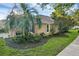 Beautiful exterior with lush landscaping and a cozy bench near the front door at 215 Foxglove Way, Deland, FL 32724