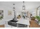 Kitchen with island sink and dishwasher, opens to dining and showcases open shelving at 215 Foxglove Way, Deland, FL 32724