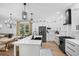 Bright kitchen features stainless steel appliances, modern countertops, farmhouse sink, and stylish lighting at 215 Foxglove Way, Deland, FL 32724