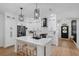 Modern kitchen with white cabinets, stainless appliances, center island, and bar stool seating at 215 Foxglove Way, Deland, FL 32724