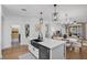 Kitchen with island sink and dishwasher, opens to dining and showcases open shelving at 215 Foxglove Way, Deland, FL 32724