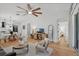 Open living and dining area with stylish furnishings and lots of natural light from large windows and sliding door at 215 Foxglove Way, Deland, FL 32724