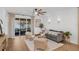 Bright living room features modern furnishings, fan, wood floors, and a sliding door to an outdoor seating area at 215 Foxglove Way, Deland, FL 32724