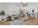 Open concept living room features recessed lights, wood floors and seamless transition to a modern white kitchen at 215 Foxglove Way, Deland, FL 32724