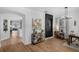 Open-concept living room with wooden floors, and access to the modern kitchen and dining area at 215 Foxglove Way, Deland, FL 32724