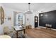 Spacious living room with natural light, wooden floors, and a decorative black accent wall at 215 Foxglove Way, Deland, FL 32724
