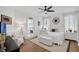 The main bedroom features a white palette, modern decor, wood floors, ensuite bathroom and lots of natural light at 215 Foxglove Way, Deland, FL 32724