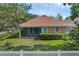 Charming home with a lovely screened-in porch and well-manicured lawn and mature trees at 215 Foxglove Way, Deland, FL 32724