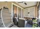 Cozy screened-in porch with wicker furniture, hanging chair, and ceiling fan at 215 Foxglove Way, Deland, FL 32724