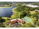 Stunning aerial view of the clubhouse, pool, tennis courts, and scenic lake enhancing the community's appeal at 236 Afton Sq # 109, Altamonte Springs, FL 32714